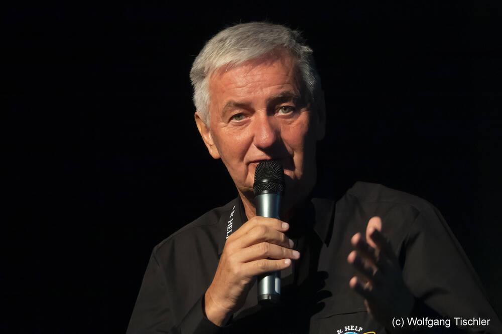 Reiner Meutsch mit Mikrofon; Reiner Meutsch hält Vortrag